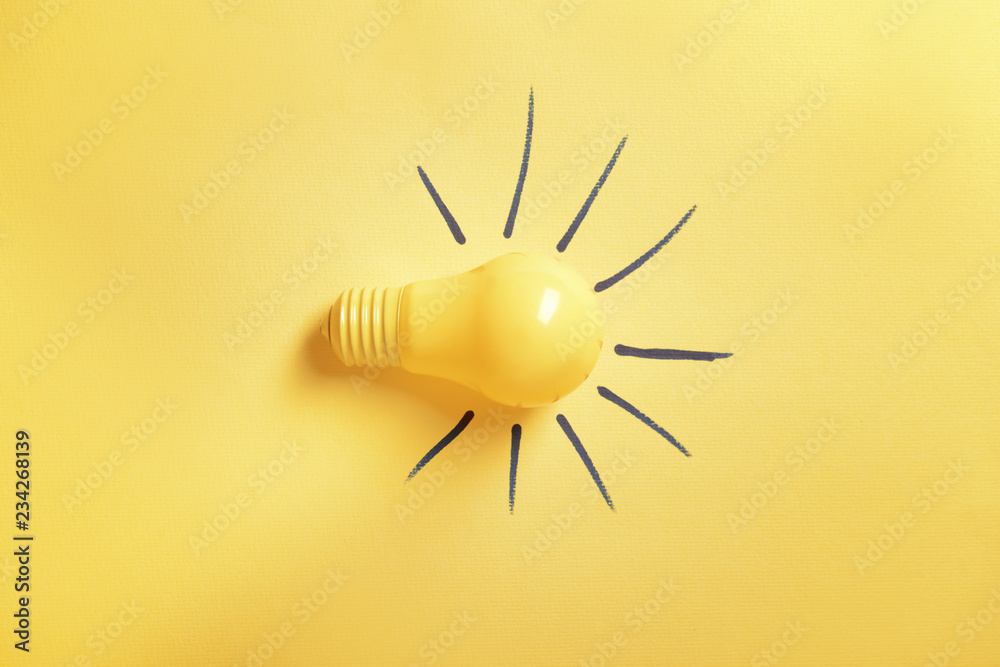 Light bulb on color background