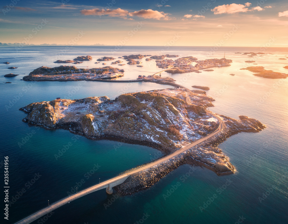 Aerial view of bridge over the sea and snowy mountains in Lofoten Islands, Norway. Henningsvaer at s