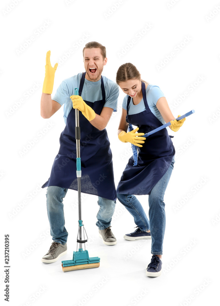 Man and woman having fun with cleaning supplies on white background
