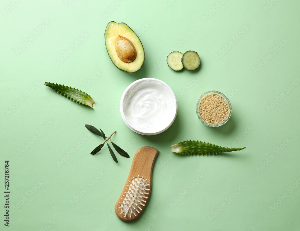 Flat lay composition with avocado and natural cosmetics for hair on color background