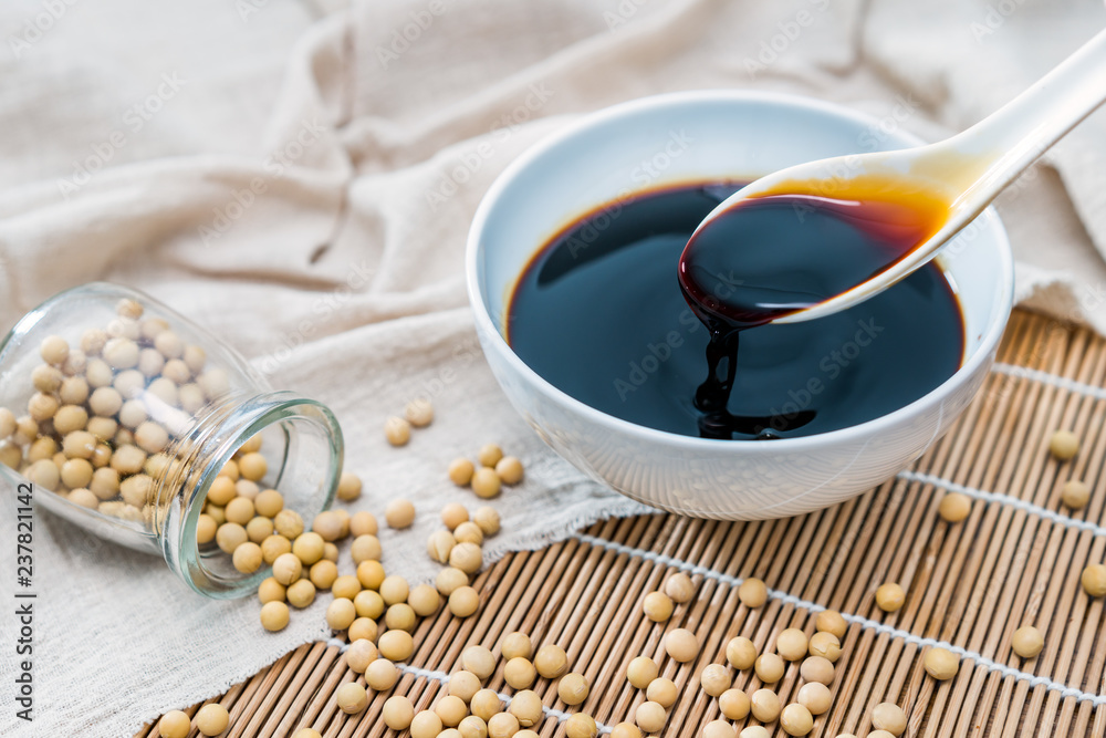A bowl of soy sauce and sprinkled soybeans