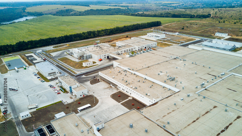 Top view of modern big factory with white buildings. Industrial complex. Aerial view.