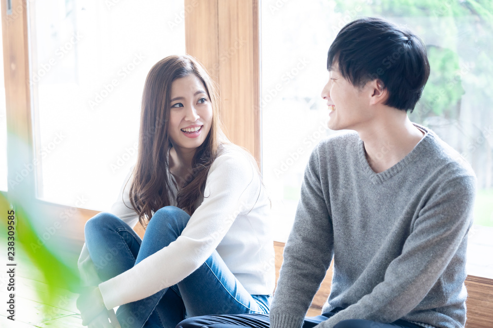 年轻的亚洲夫妇在客厅放松