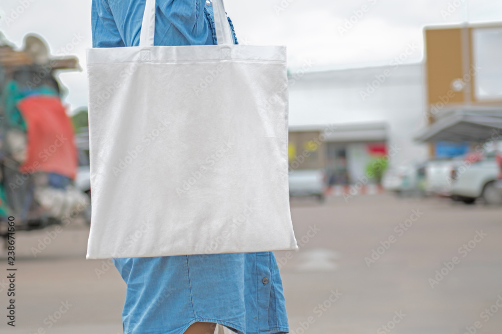 woman holding cotton bag for shopping. eco concept