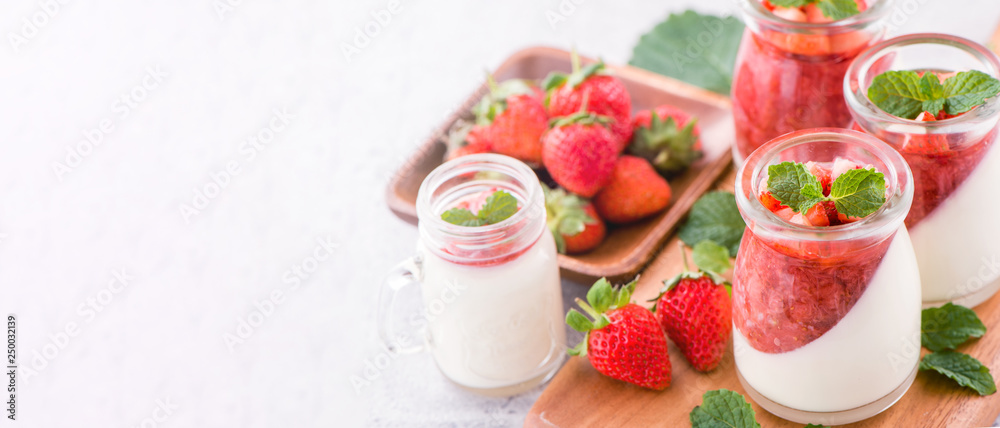 Delicous and nutritious double color (colour) strawberry desserts with mint and diced sarcocarp topp