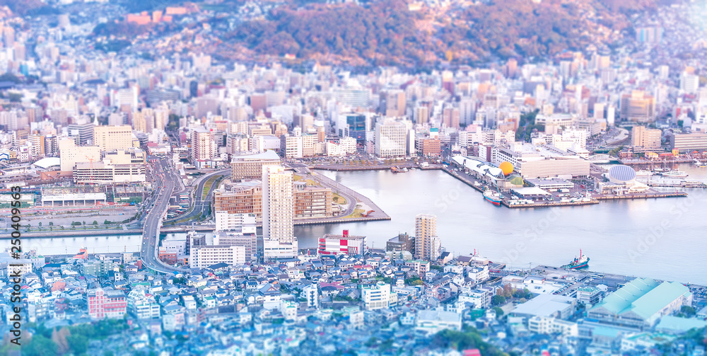 Business concept, tilt shift effect modern cityscape of nagasaki dusk from mount inasa, the new top 
