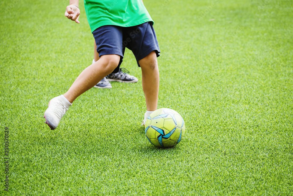 Kids running and kicking soccer ball