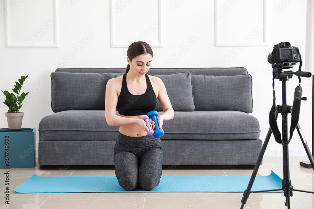 Female blogger recording sports video indoors