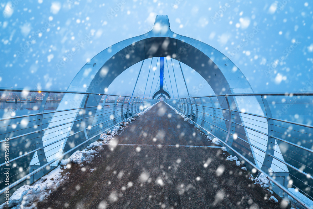 Solvesborgsbron pedestrian bridge with falling snow in the south of Sweden
