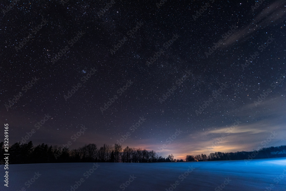 dark sky full of shiny stars in carpathian mountains in winter at night