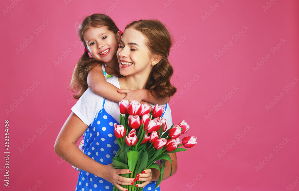 母亲节快乐！小女儿送给母亲一束粉红色背景的花。
