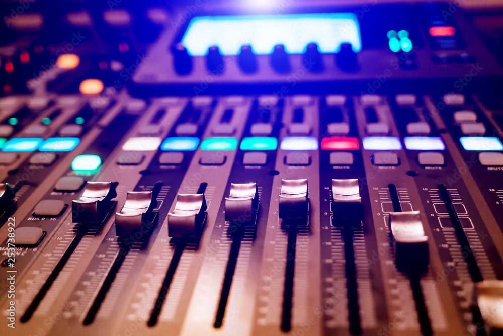 DJ使用带音量控制器的专业音乐会混音控制台录制音乐。特写