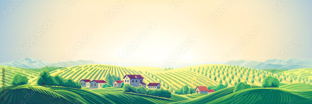 Rural panoramic landscape with a village and hills with gardens and fruit trees