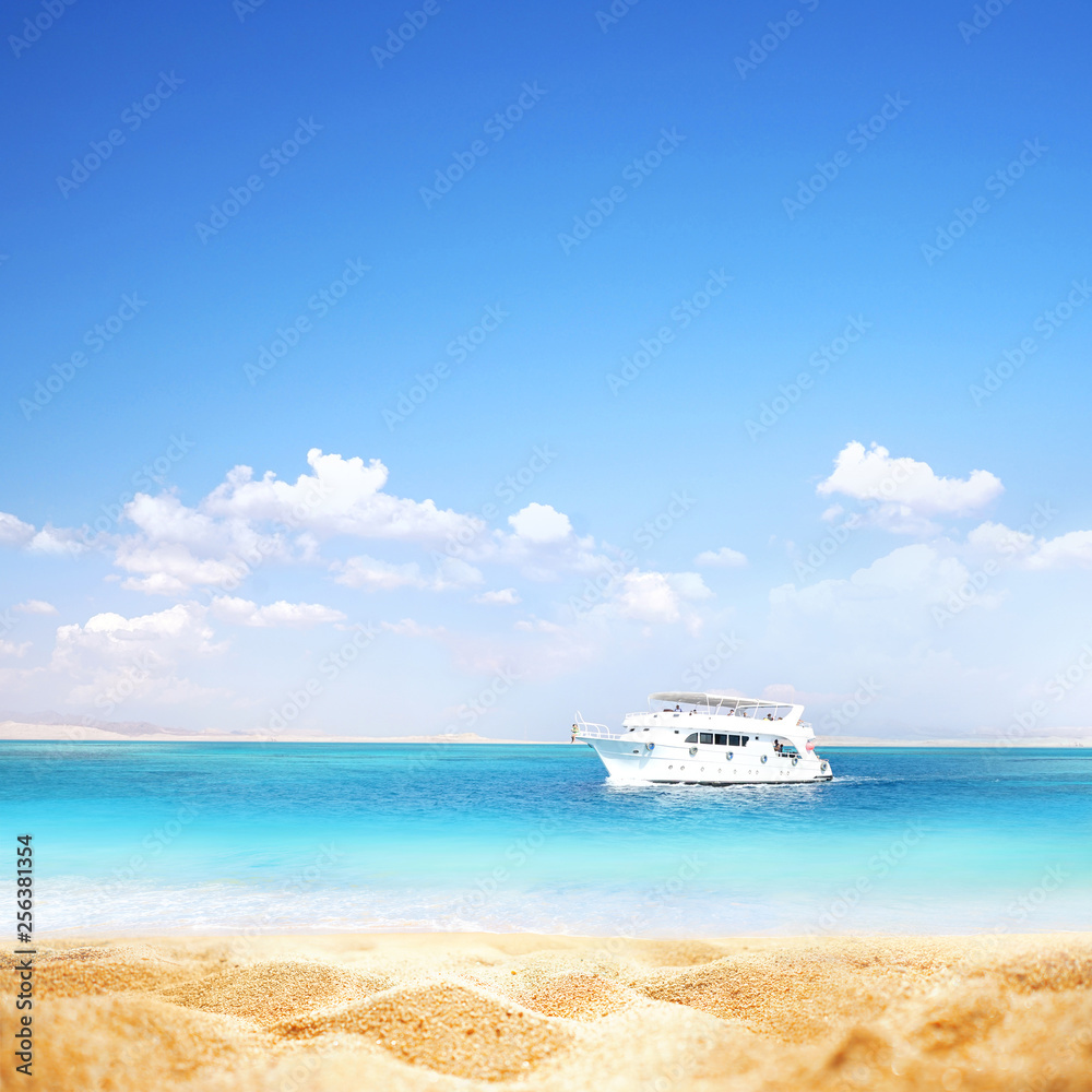 Summer background, nature of tropical golden beach with blue sky and white clouds. Golden sand beach