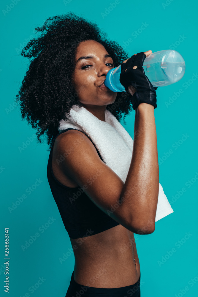 Muscular woman taking break after exercise