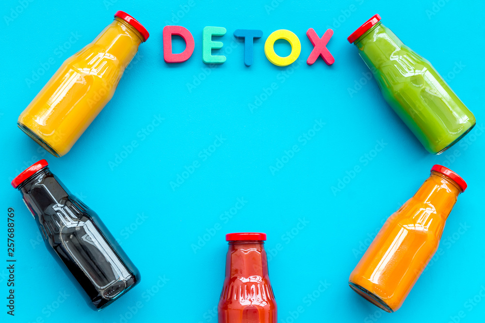 bottles with fresh carrot, tomato, apple, cucumber, lemon, pomegranate juices on blue background top