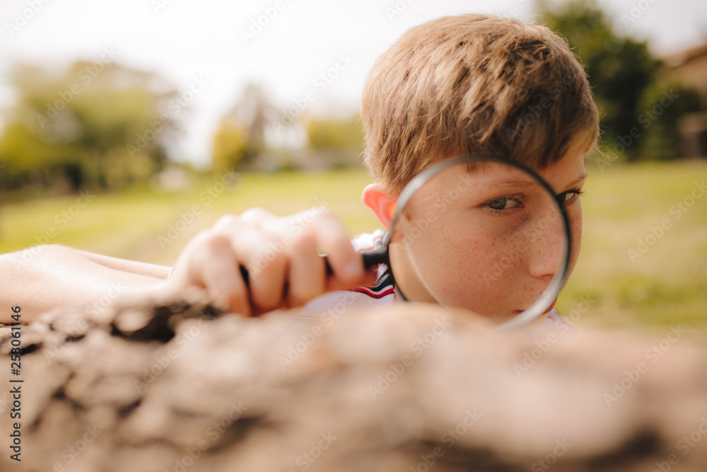 Boy exploring with magnifying glass