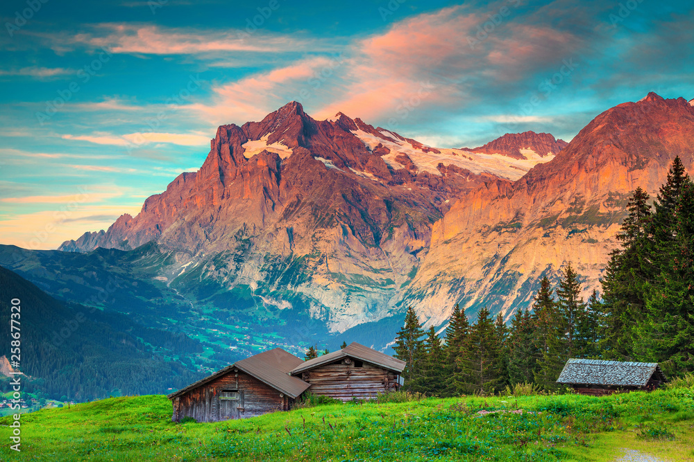 Amazing summer alpine landscape with old wooden lodges, Grindelwald, Switzerland
