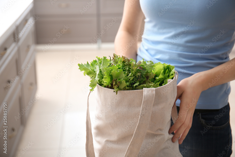 室内环保袋里装着新鲜蔬菜的年轻女子
