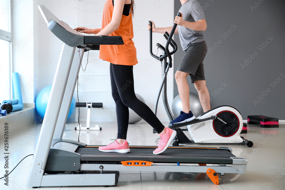 运动型年轻人在健身房用机器训练