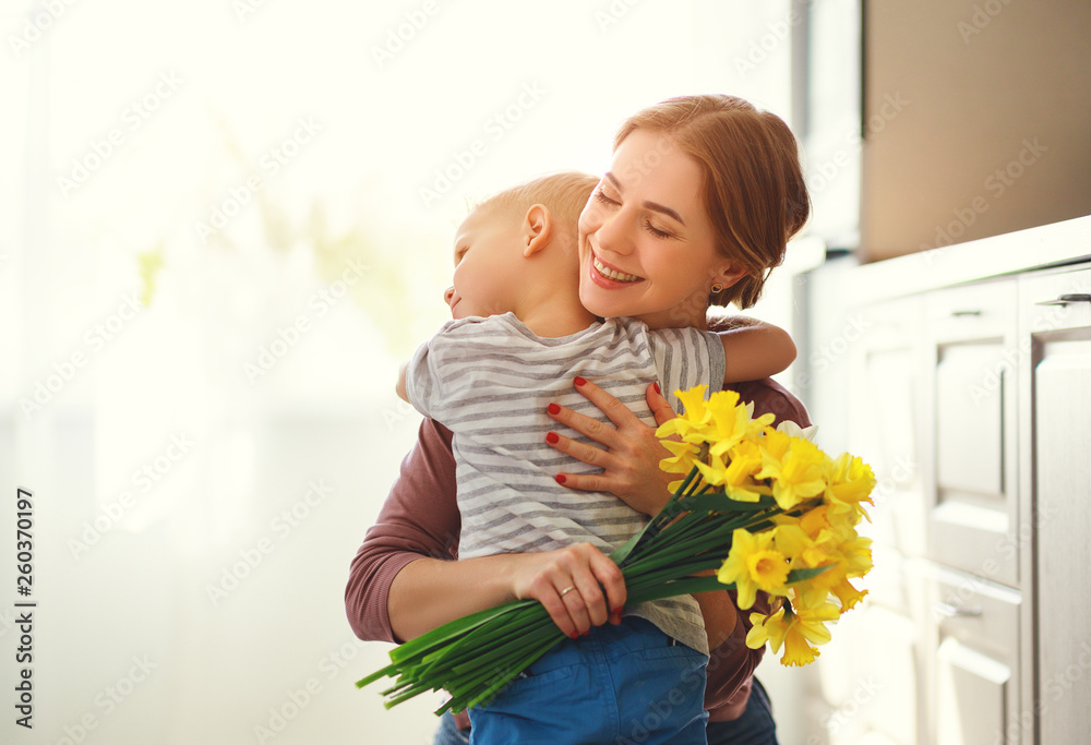 happy mothers day! child son gives flowersfor  mother on holiday .