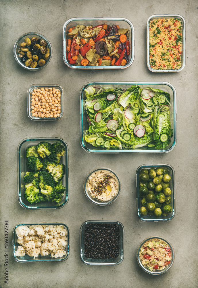 Healthy vegan dishes in containers. Flat-lay of vegetable salads, legumes, beans, olives, sprouts, h