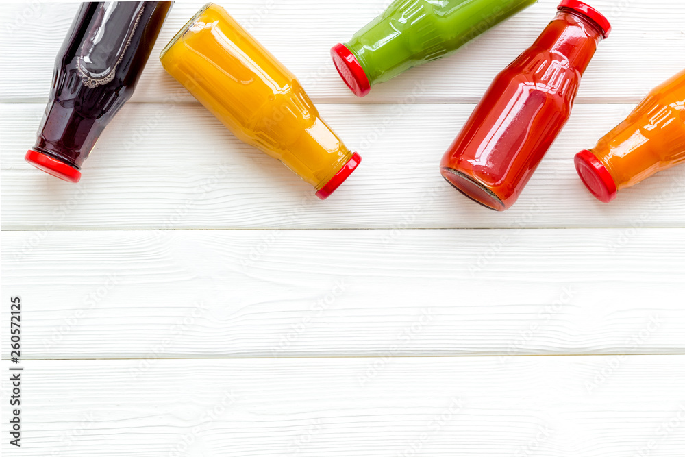 fresh organic juices in bottles for fitness diet on white wooden background top view mock-up