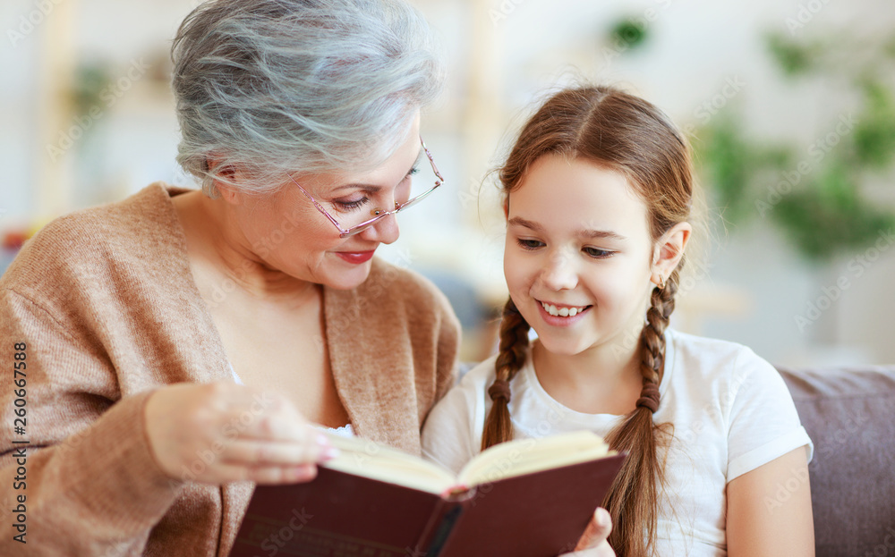 幸福家庭的祖母在家给孙女读书