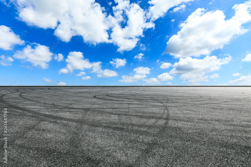 Empty asphalt race track ground and beautiful sky clouds