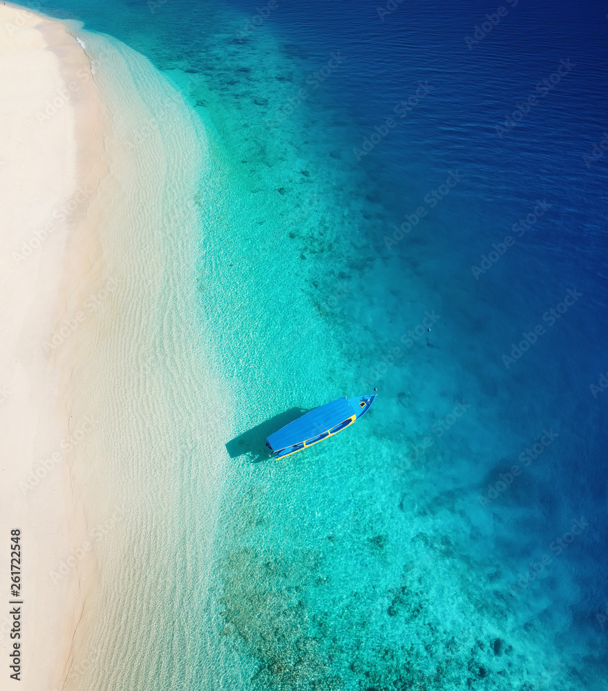 Boat on the water surface from top view. Turquoise water background from top view. Summer seascape f
