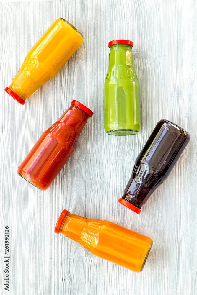 bottles with fresh carrot, tomato, apple, cucumber, lemon, pomegranate juices on white background to