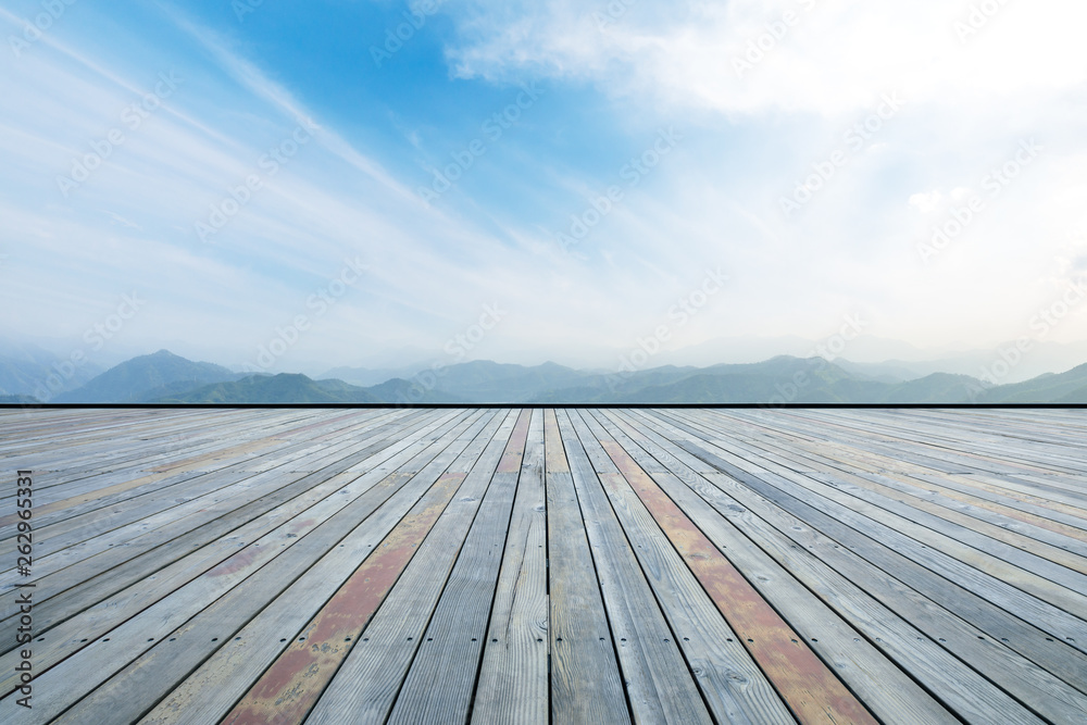 Empty wooden planks platform and mountain with clouds landscape