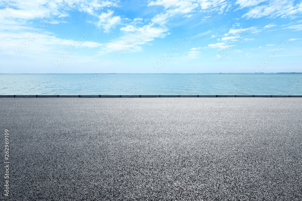 Empty asphalt road and sea with beautiful clouds