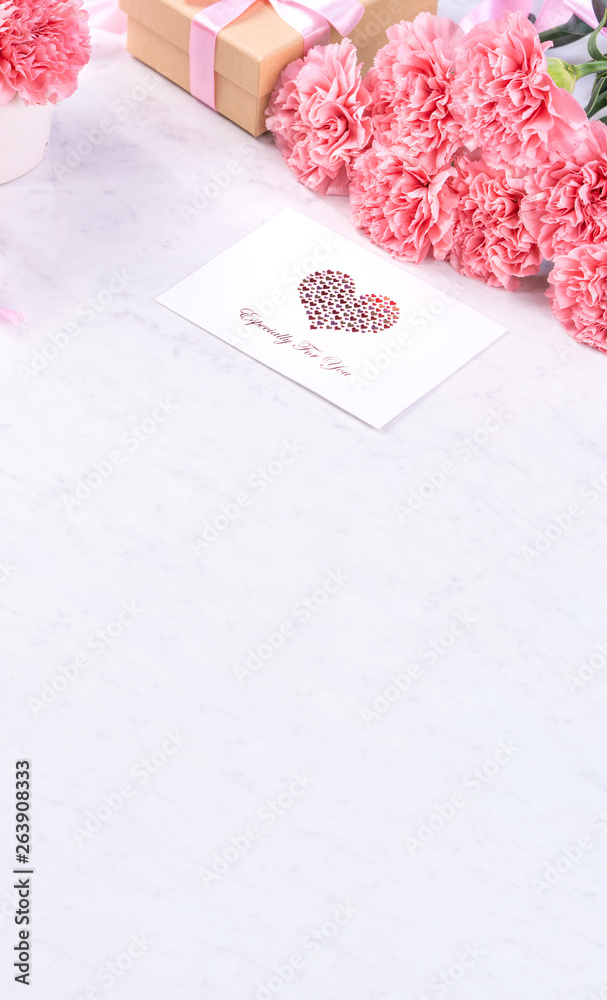 Design concept - Beautiful bunch of carnations on marble white background, top view, copy space, clo
