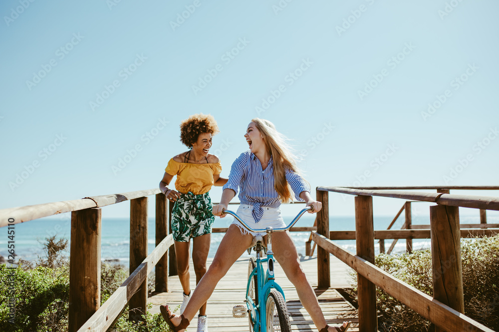 Friends enjoying themselves with a bike