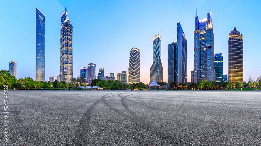 Asphalt race track ground and modern skyline and buildings in Shanghai at night,panoramic view