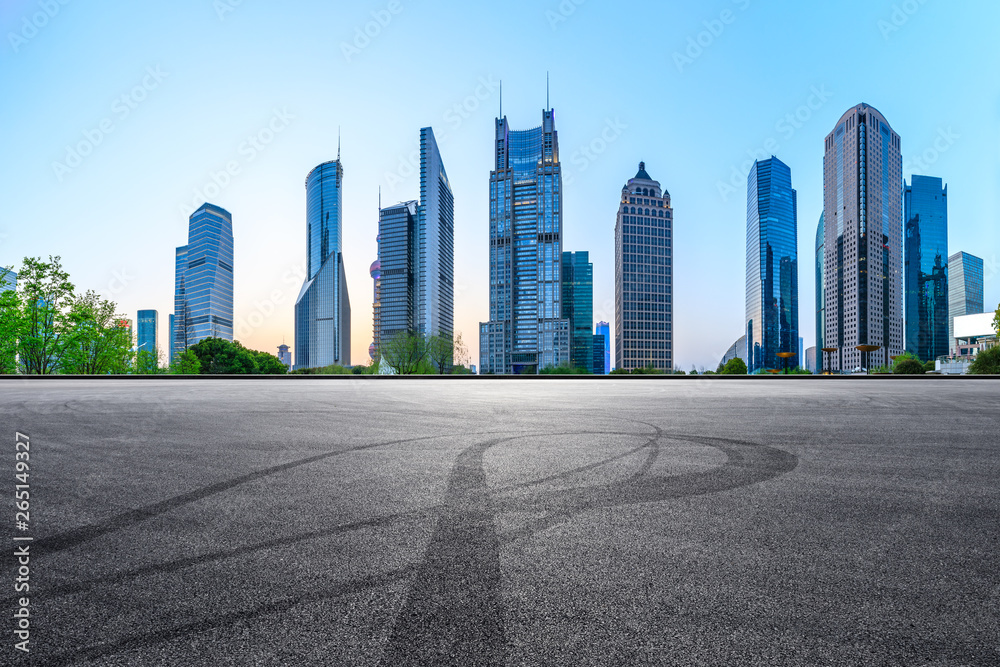 Asphalt race track ground and modern skyline and buildings in Shanghai at night,panoramic view