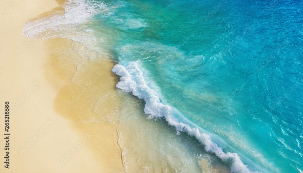 Beach as a background from top view. Waves and azure water as a background. Summer seascape from air