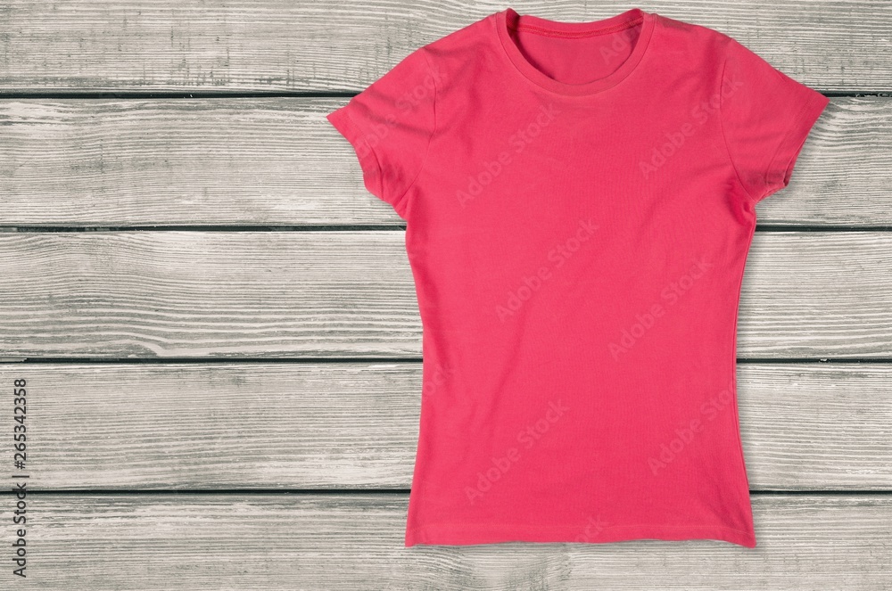 Top view of white T-Shirt on wooden background