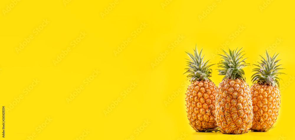 Beautiful fresh pineapple isolated on bright yellow background, summer seasonal fruit design idea pa