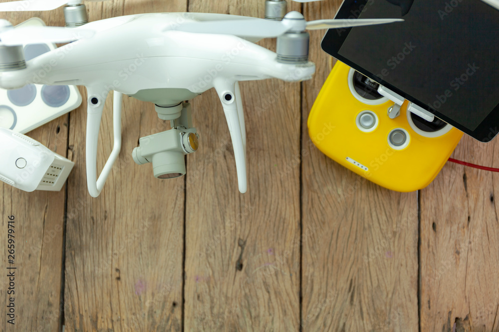 Drone equipment with Remote control on old wooden background, copy space for your text Top view imag