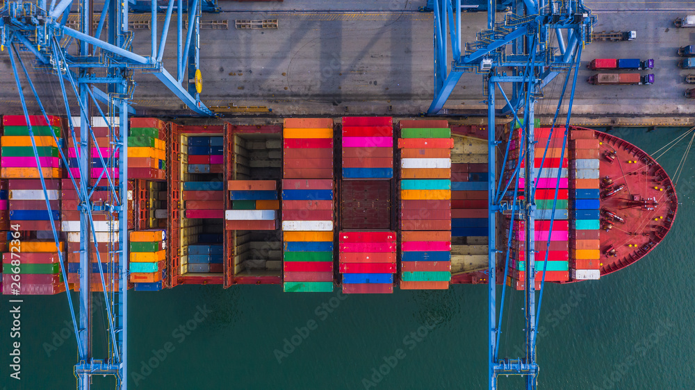Container ship loading and unloading in deep sea port, Aerial top view of logistic import export tra