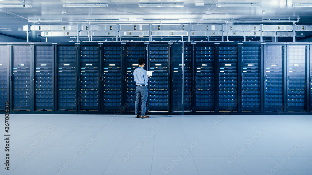 In the Modern Data Center: IT Engineer Standing Beside Open Server Rack Cabinets, Does Wireless Main