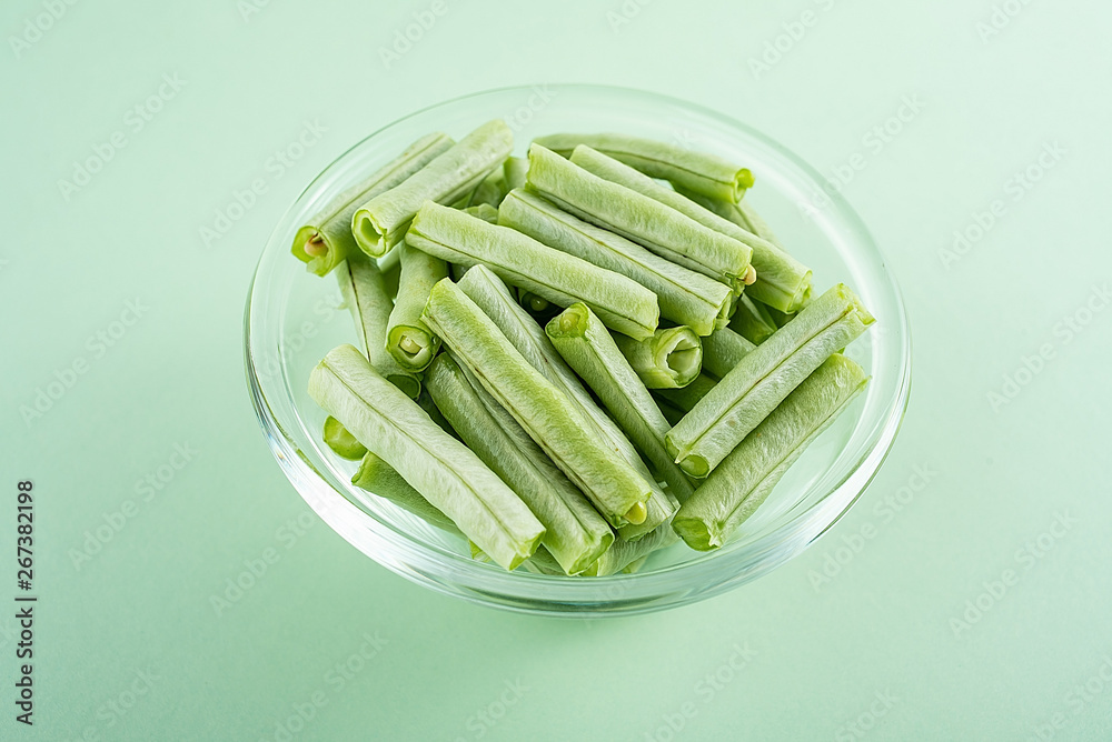 一碗浅绿色背景的芸豆新鲜蔬菜