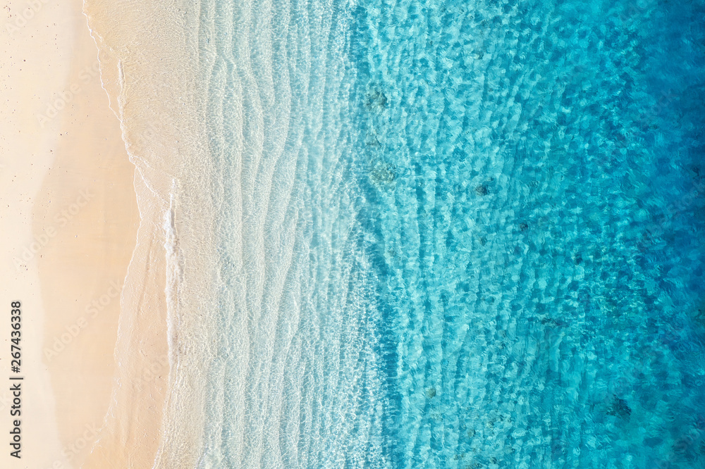 Beach and ocean as a background from top view. Azure water background from top view. Summer seascape