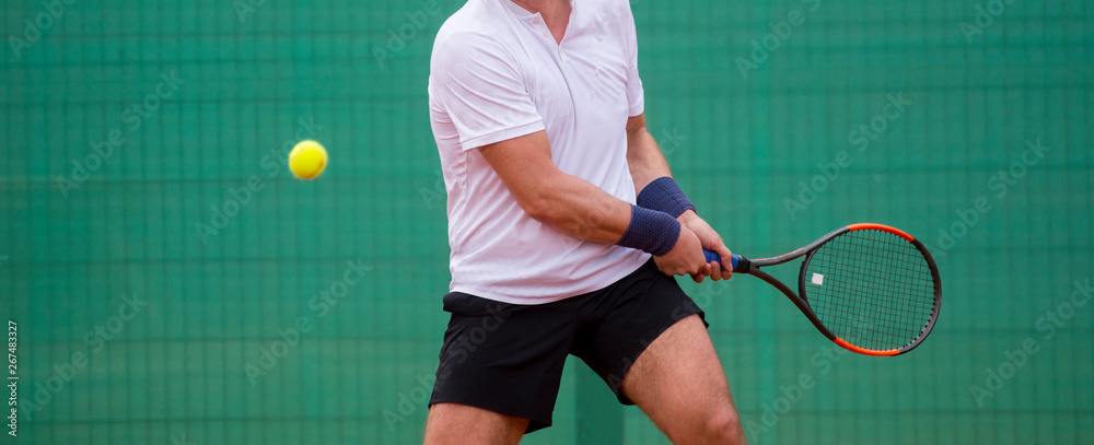 Male tennis player in action on the court