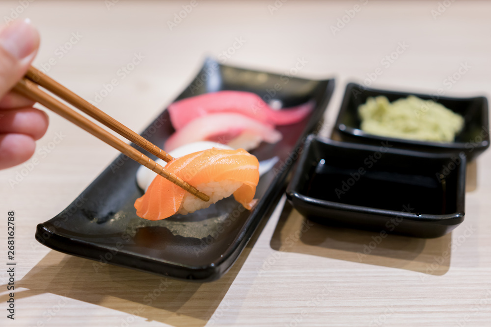 Sushi roll with salmon and and fresh mix sushi set in black plate - Japanese food set style at Japan