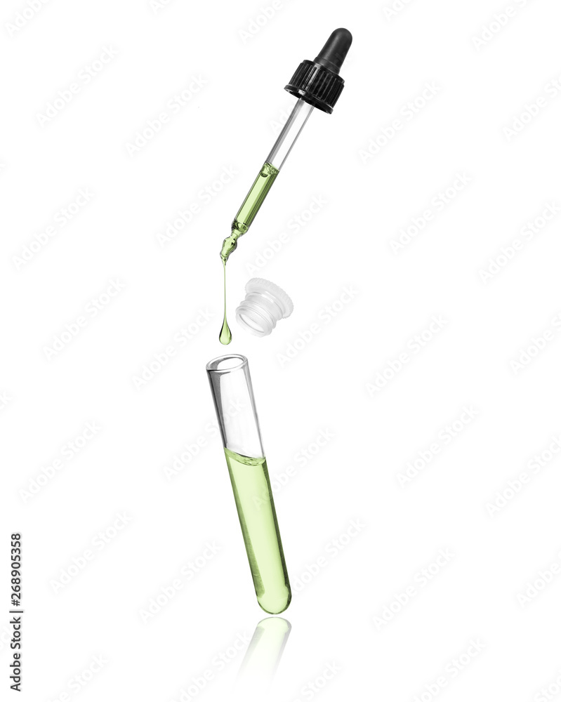 Drop drops from a pipette in a vial on white background