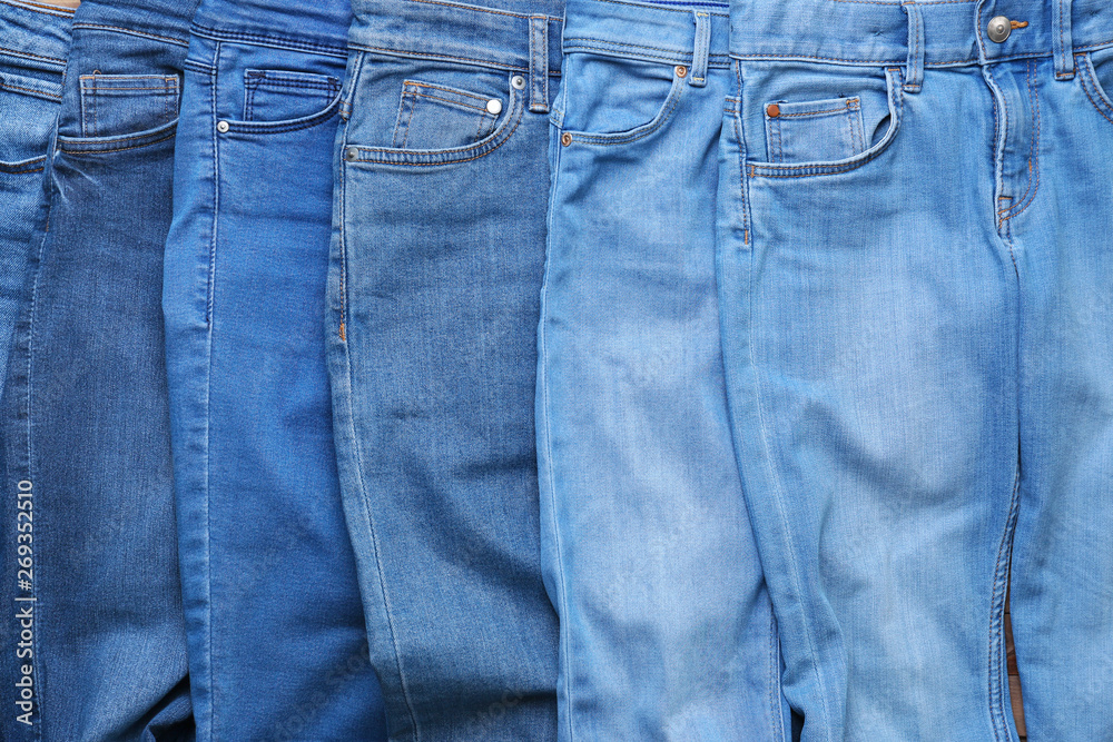 Different stylish jeans pants, closeup