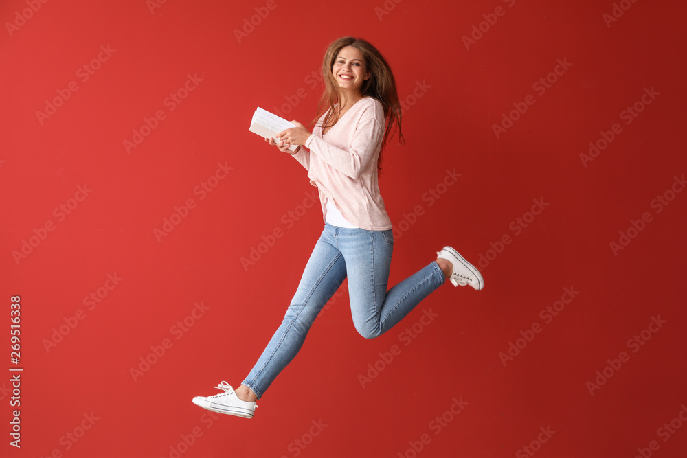 跳跃的年轻女子，彩色背景的书